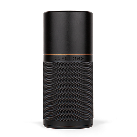 Dark refillable deodorant with knurled texture, small bronze details and a logo saying Lifelong in the middle.